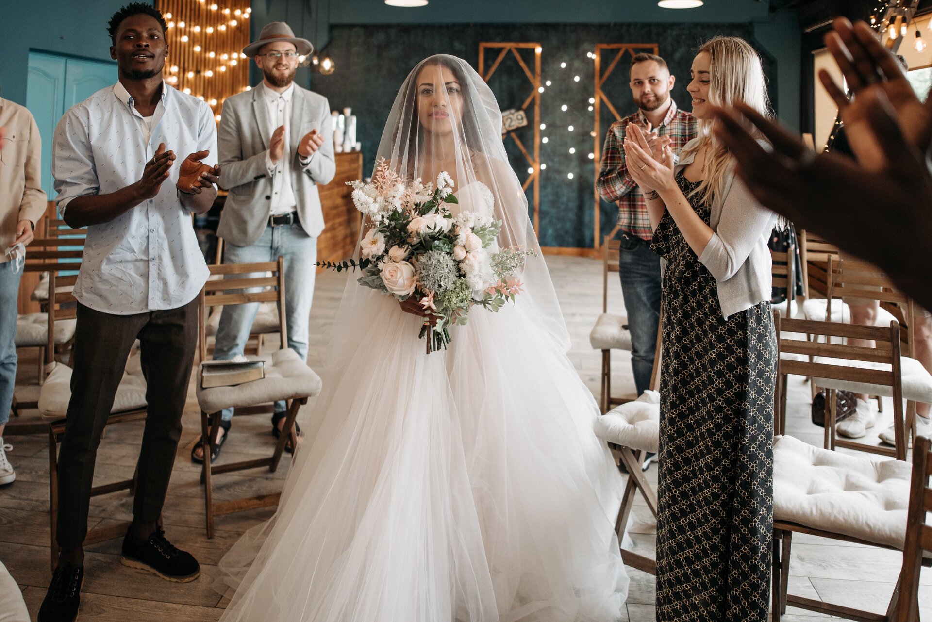 Ashley walking down the aisle surrounded by people.